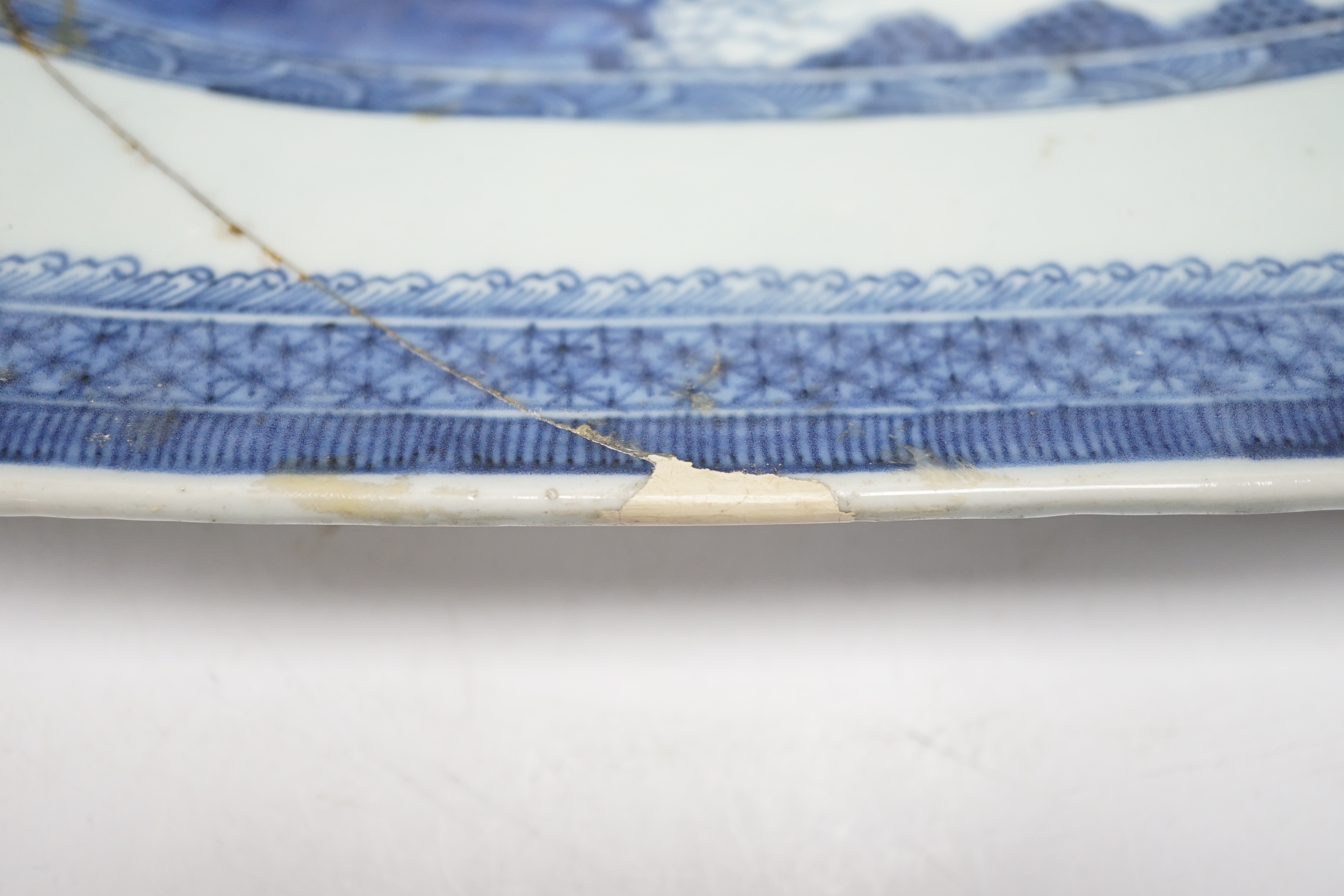 An early 19th century Chinese export blue and white dish, 51cm (a.f.)